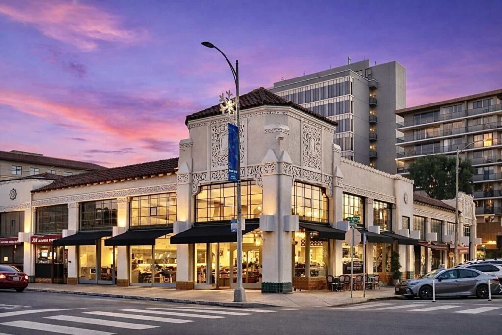 The corner building housing Whisper on Baldwin Avenue in San Mateo at dusk